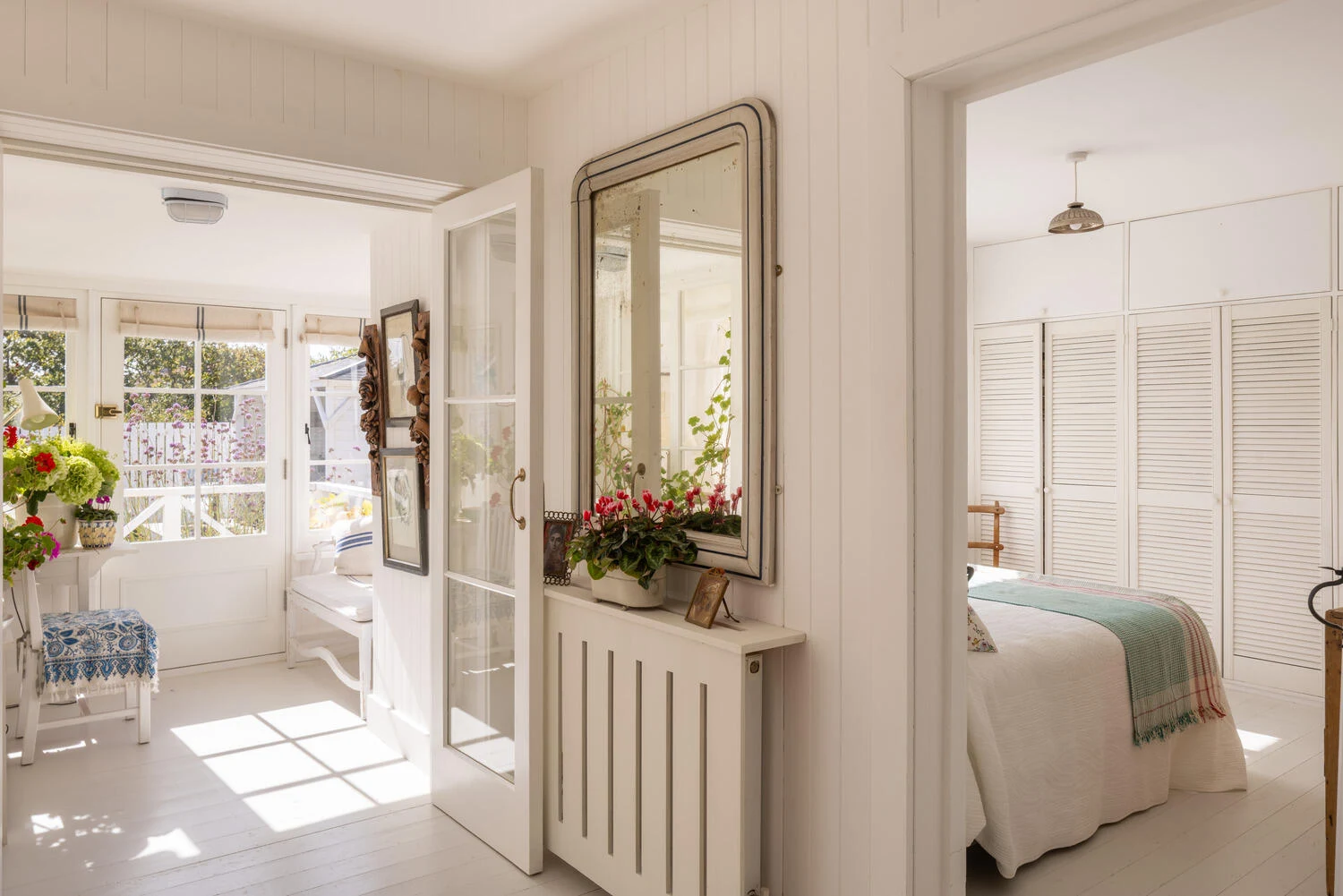 White hall with mirror and radiator