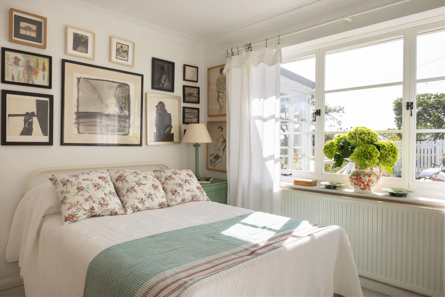 Bedroom with white walls and garden-facing window