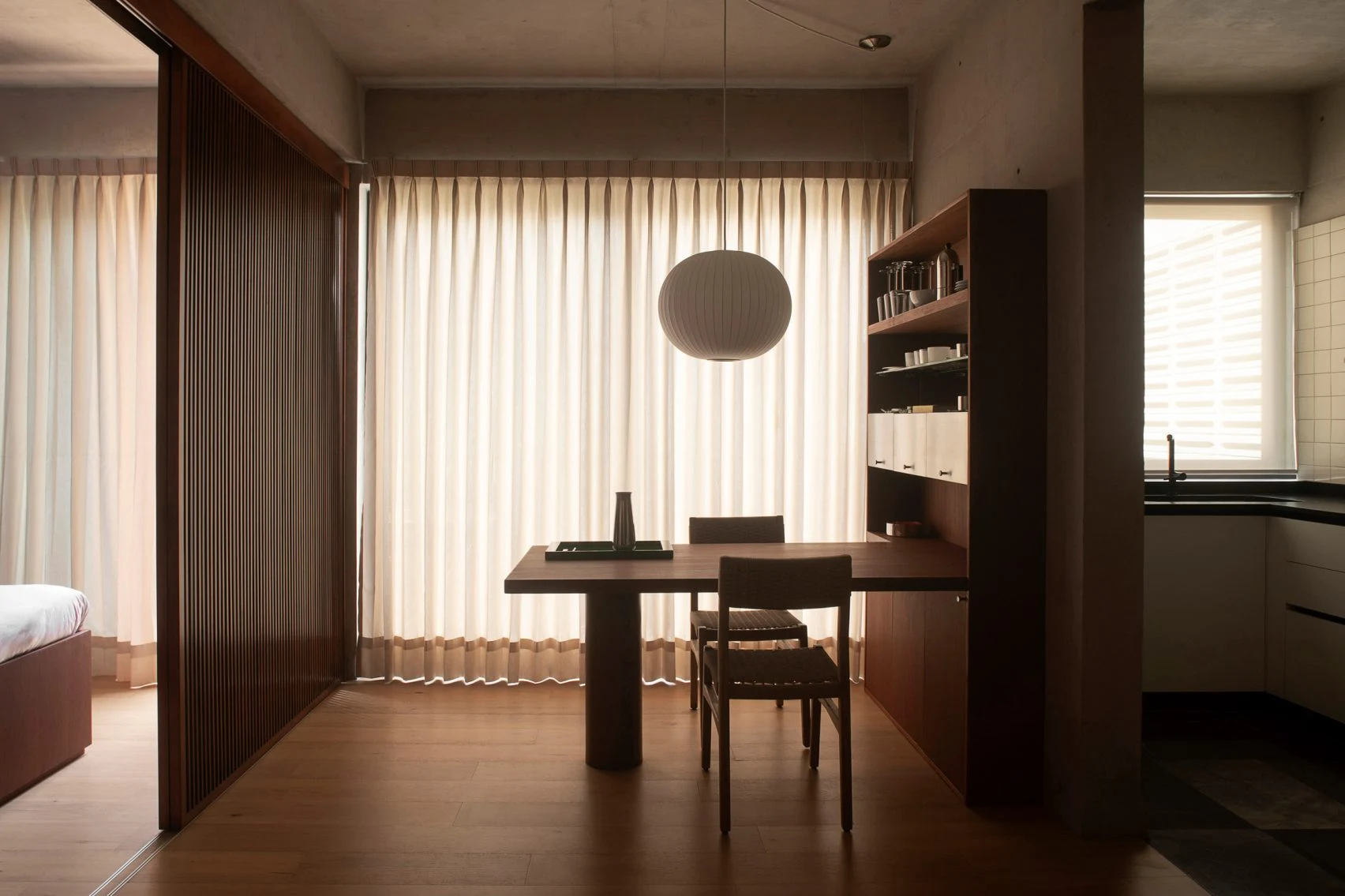 Wide view of the dining area, wood flooring and concrete ceiling