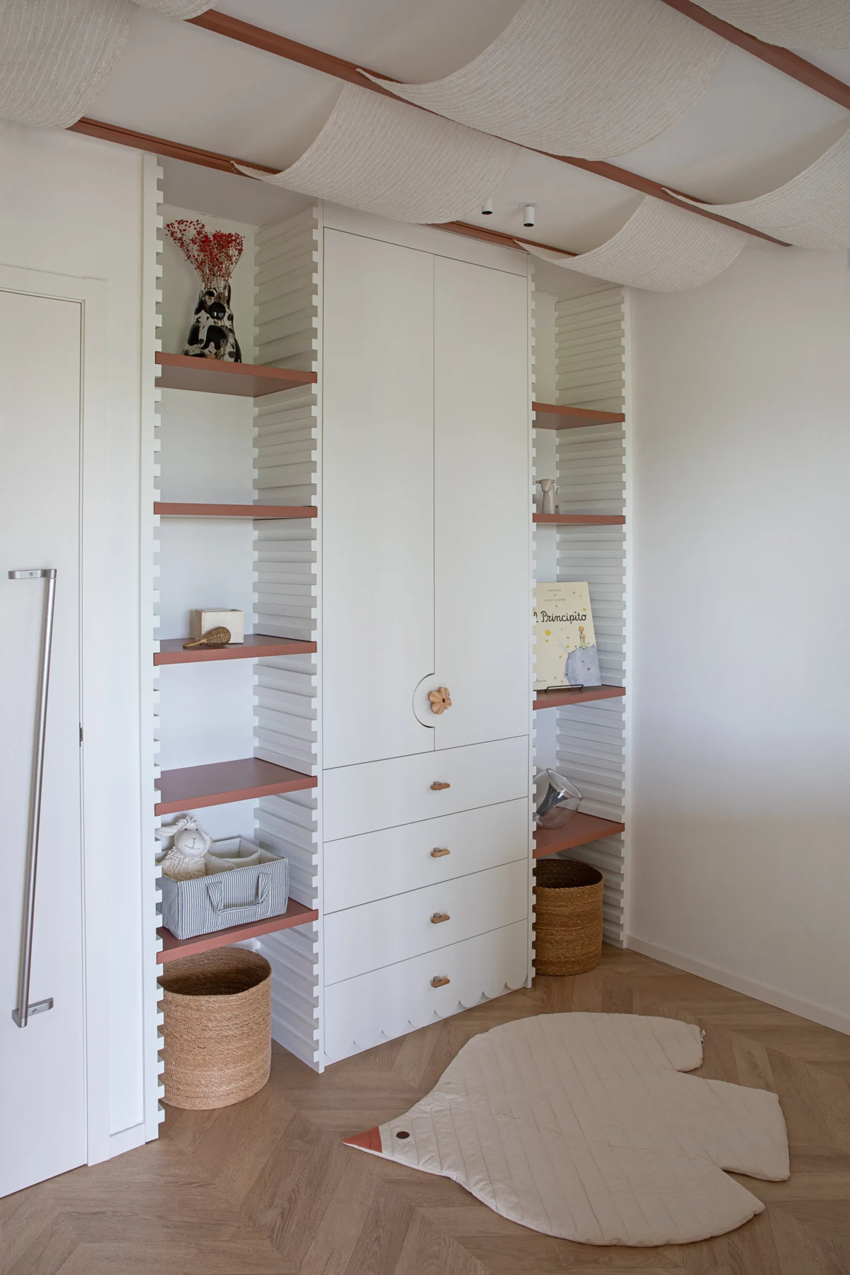 White wardrobe with central cupboard doors and drawers flanked by adjustable open timber shelves