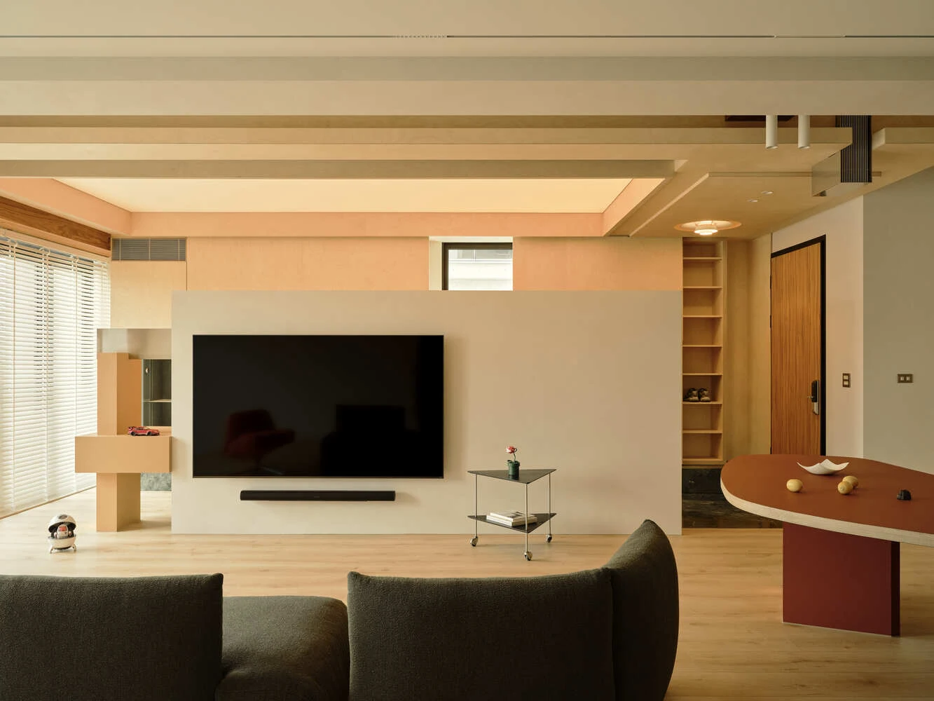 TV mounted on a layered central partition with offset volumes and open space above